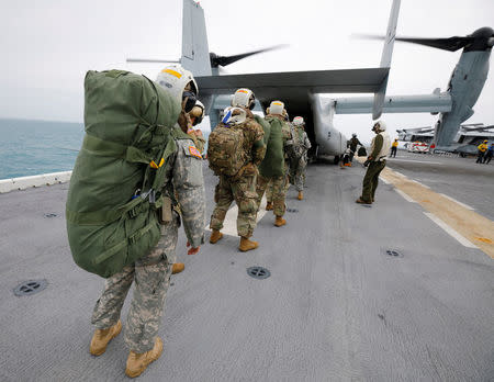 Soldiers from the Army's 602nd Area Support Medical Company board a MV-22 Osprey bound for St. Thomas in the U.S. Virgin Islands, on the flight deck of the USS Kearsarge September 22, 2017. REUTERS/Jonathan Drake