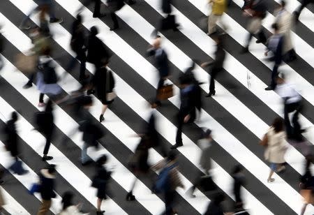 People cross a street in Tokyo in this March 18, 2015 file photo. REUTERS/Yuya Shino/Files