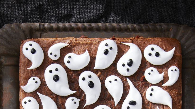 a tray of brownies with marshmallow ghosts all over
