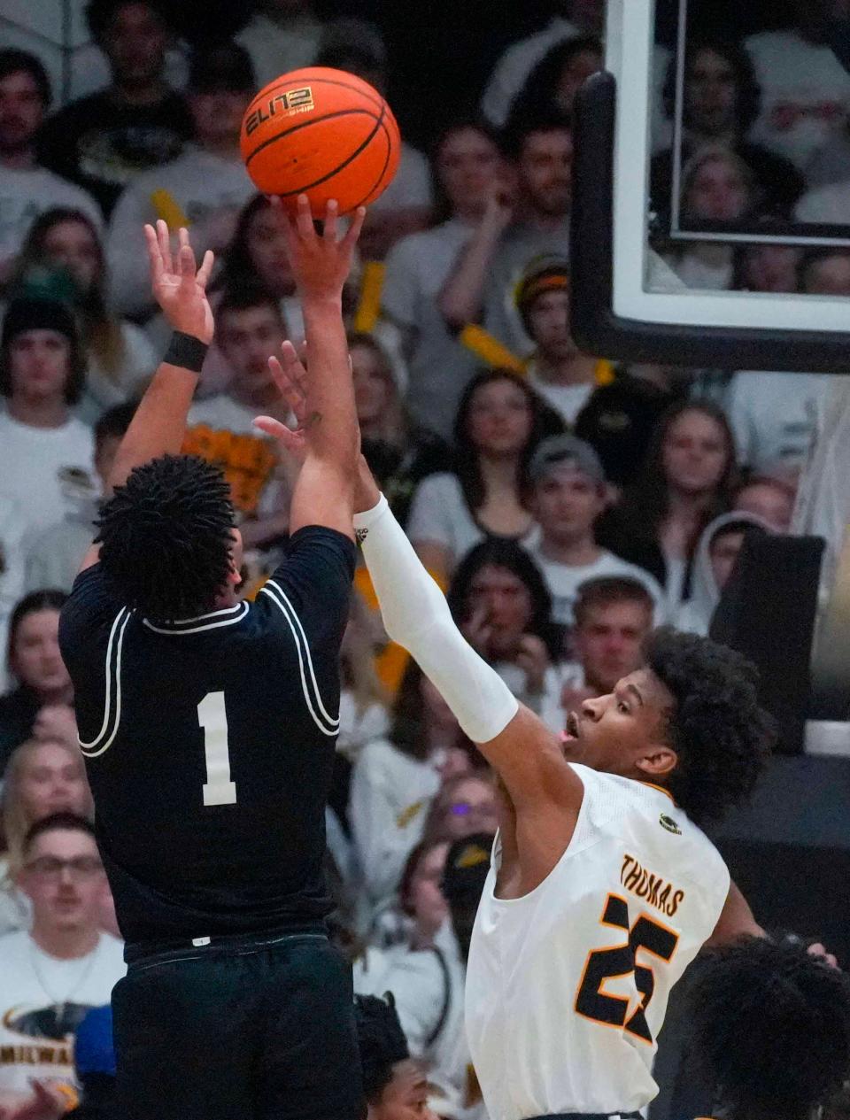 Wright State Raiders guard Trey Calvin (1) shoots a jump shot while Milwaukee Panthers guard Justin Thomas (25) plays defense during the first half of their of their quarterfinal game of the Horizon League Tournament on Thursday, March 2, 2023, at Klostche Center in Milwaukee.