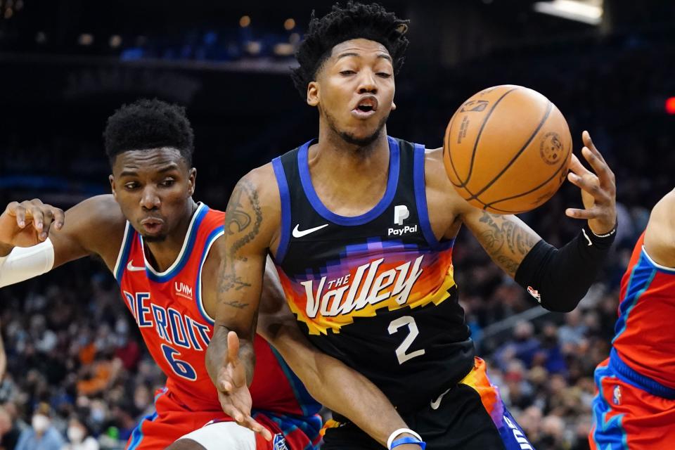 Phoenix Suns guard Elfrid Payton (2) vies for a rebound with Detroit Pistons guard Hamidou Diallo (6) during the first half of an NBA basketball game Thursday, Dec. 2, 2021, in Phoenix. (AP Photo/Ross D. Franklin)