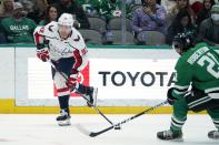 Washington Capitals center Evgeny Kuznetsov (92) controls the puck in front of Dallas Stars left wing Jason Robertson (21) in the second period of an NHL hockey game in Dallas, Friday, Jan. 28, 2022. (AP Photo/Tony Gutierrez)