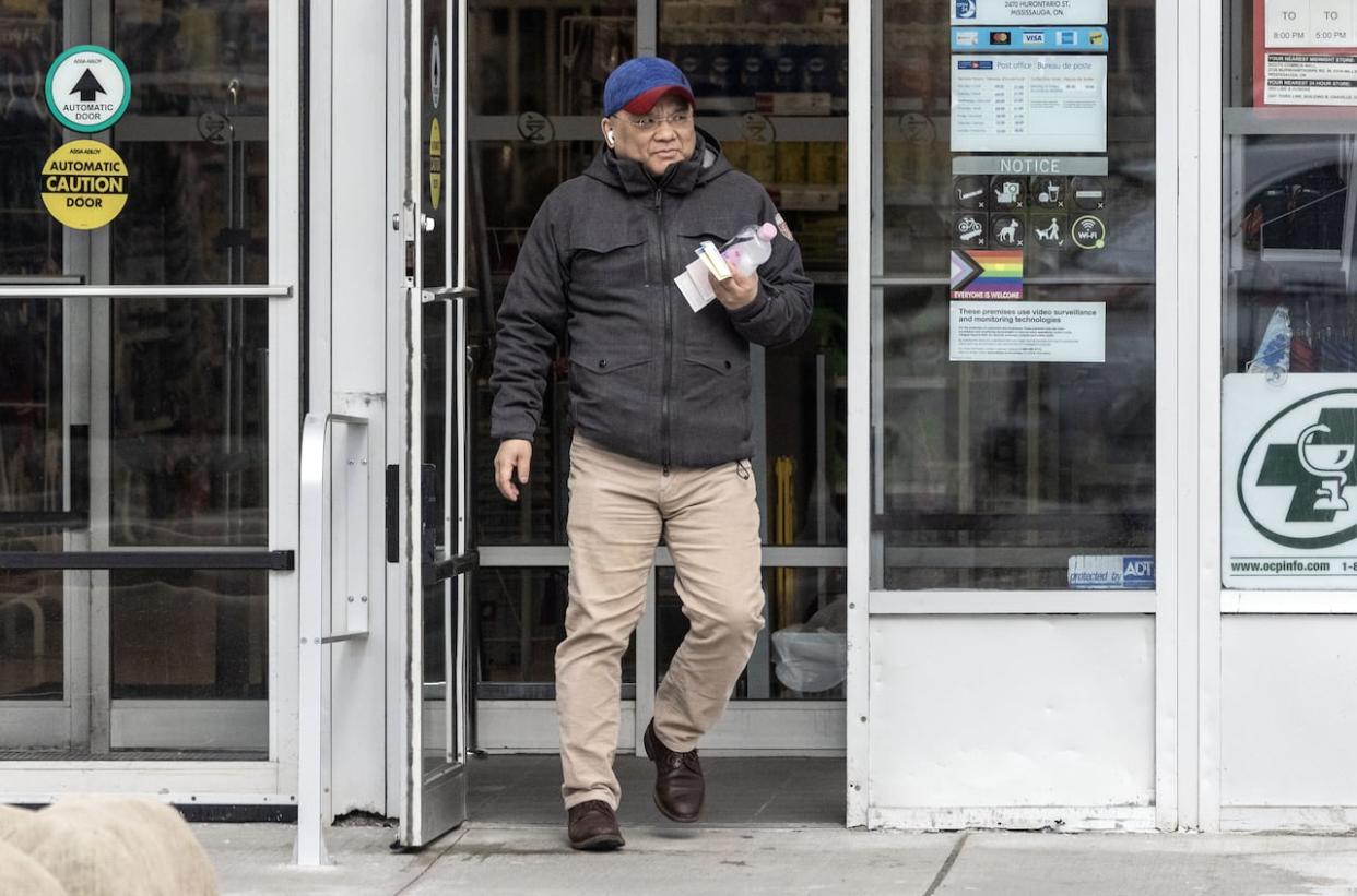 Kenneth Law is seen outside the Mississauga, Ont. pharmacy where a post office box is linked to him. Law has been charged with murder in connection to multiple deaths in Ontario, CBC News has learned.  (The Times/News Licensing - image credit)