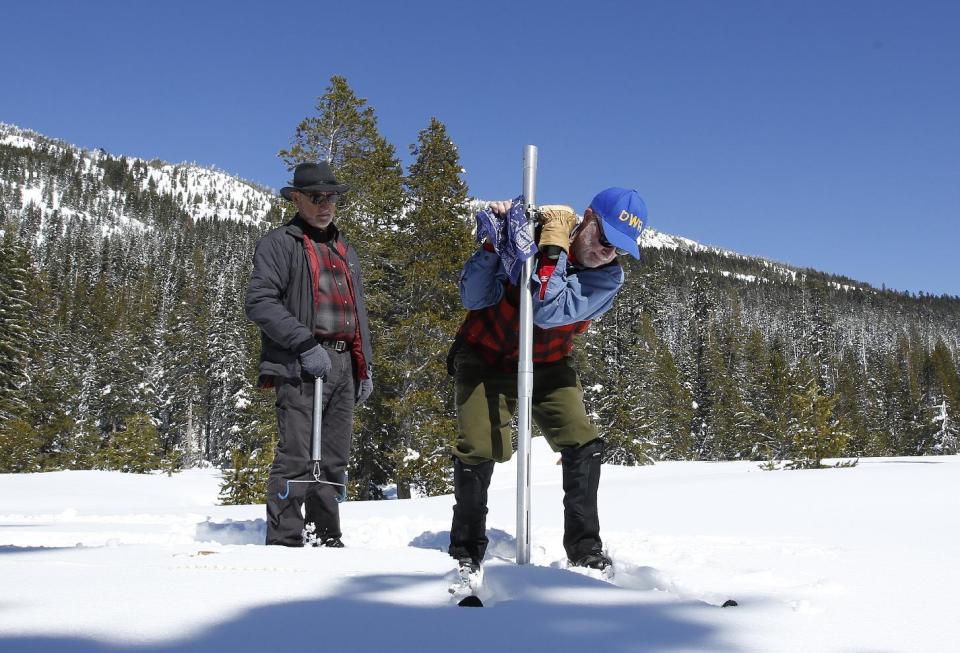 Frank Gehrke, right, chief of the California Cooperative Snow Surveys Program for the Department of Water Resources, plunges the survey tube into the snowpack as he conducts the third manual snow survey of the season at Phillips Station, Wednesday, March 1, 2017, near Echo Summit, Calif. The survey showed the snowpack at 179 percent of normal for this location at this time of year. The state's electronic snow monitors say the Sierra Nevada snowpack is at 185 percent of normal. At left is Armando Quintero chairman of the California Water Commission.(AP Photo/Rich Pedroncelli)