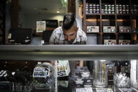 FILE - In this June 27, 2017, photo, Jerred Kiloh, owner of the Higher Path medical marijuana dispensary, stocks shelves with with cannabis products in Los Angeles. Kiloh, who also heads the United Cannabis Business Association, a Los Angeles-based trade association said "No one is making money anywhere in the (legal) supply chain," he said, noting that his own sales have nosedived. Kiloh sees few bright spots from passage of the 2016 law, beyond a testing program that safeguards quality and programs to expunge old criminal records for marijuana. With Proposition 64, "We did it all wrong," he said. (AP Photo/Jae C. Hong,File)