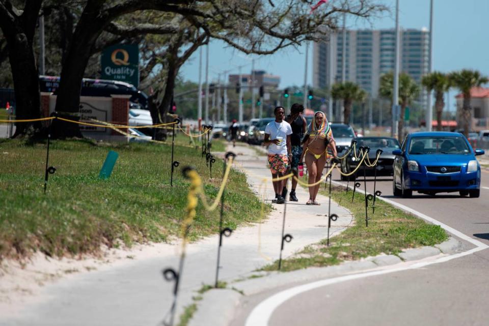 Spring breakers walk along Highway 90 in Biloxi during Black Spring Break on Saturday, April 13, 2024. Vendors who usually operate along the road during the event were not permitted due to a denied special event permit.