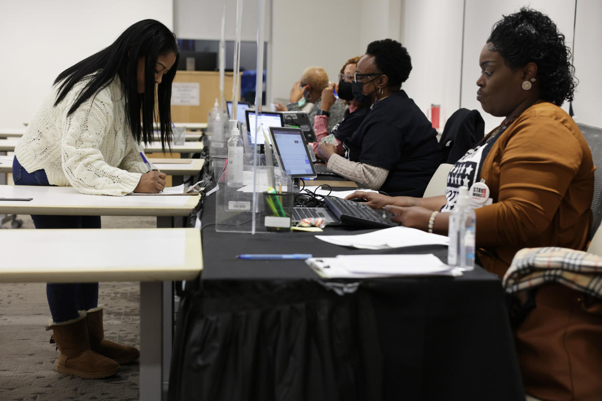 A resident fills out paperwork before early voting at a polling station in Atlanta (Alex Wong / Getty Images)