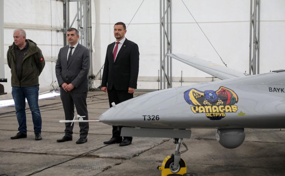 (L-R) Lithuanian Minister of National Defence Arvydas Anusauskas, Baykar CEO Haluk Bayraktar and Ukrainian Ambassador to Lithuania Petro Beshta attend the presentation of the Bayraktar TB2 combat drone at the Lithuanian Air Force Base in Siauliai, Lithuania, on July 6, 2022. - Lithuania on July 6, 2022 exhibited a crowdfunded Turkish-made military drone that it plans to send to Ukraine to help the war-torn country fight Russia's invasion.
People in the NATO member country raised 5.9 million euros for the Bayraktar TB2 drone over three days last month, before its Turkish manufacturer Baykar announced it would donate the drone free of charge. (Photo by PETRAS MALUKAS / AFP) (Photo by PETRAS MALUKAS/AFP via Getty Images)