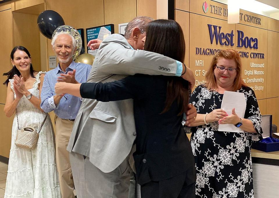 Jack Levine (left) embraces Hayley Ostrofsky at West Boca Medical Center on Wednesday.