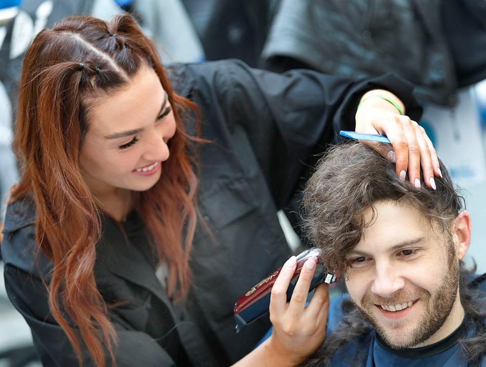 Sean Megan gets a buzz cut from Genevieve Kelly, of Hair Place One in Quincy.