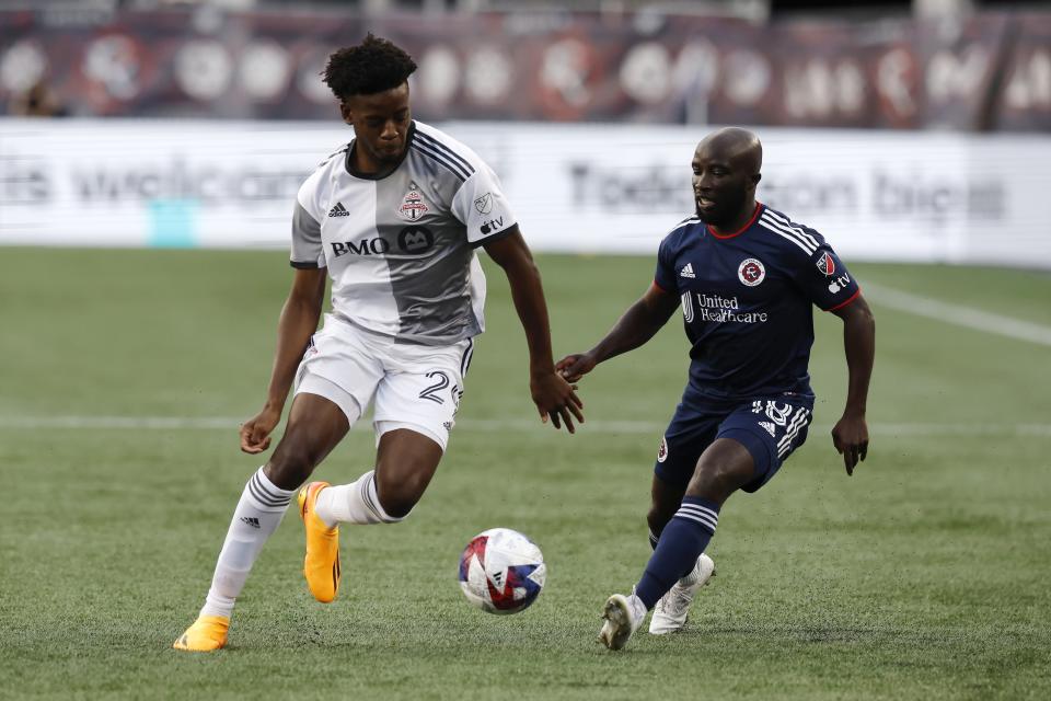 New England Revolution's Ema Boateng (18) defends against Toronto FC's Deandre Kerr (29) during the first half of an MLS soccer match Saturday, June 24, 2023, in Foxborough, Mass. (AP Photo/Michael Dwyer)