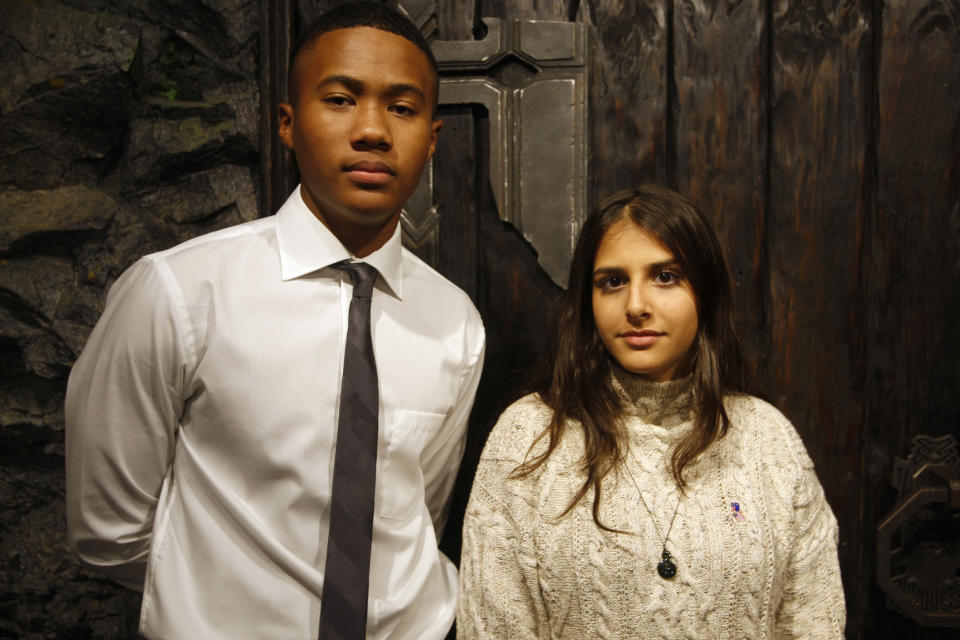 Florida students Isaac Christian, left, and Einav Cohen pose for a photo Friday, July 27, 2018, at the Weta Workshop movie effects studio in Wellington, New Zealand. They are part of a group of 28 students from Marjory Stoneman Douglas High School in Parkland, Fla., who have embraced the South Pacific nation during a trip to learn how to keep a youth movement going long after a tragedy fades from the headlines. (AP Photo/Nick Perry)