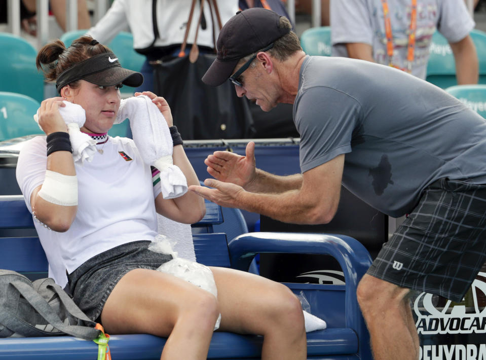 FILE - In this March 21, 2019 file photo, Bianca Andreescu, of Canada, left, talks with her coach Sylvain Bruneau during her match against Irina Camelia Begu, of Romania, at the Miami Open tennis tournament in Miami Gardens, Fla. Bruneau has released a statement, Sunday, Jan. 17, 2021, saying he was the positive coronavirus case aboard the flight from Abu Dhabi to Melbourne and he had followed all protocols and procedures, including producing a negative test within 72 hours before the flight departure and has "no idea how I might have contracted the virus." (AP Photo/Lynne Sladky, File)