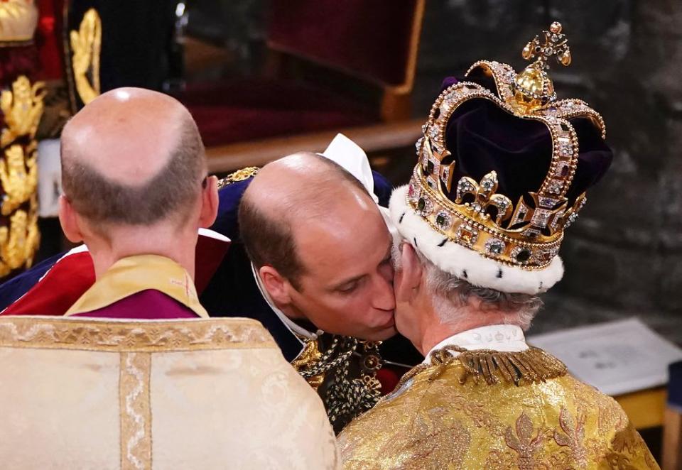 Prince William kissing King Charles during his coronation