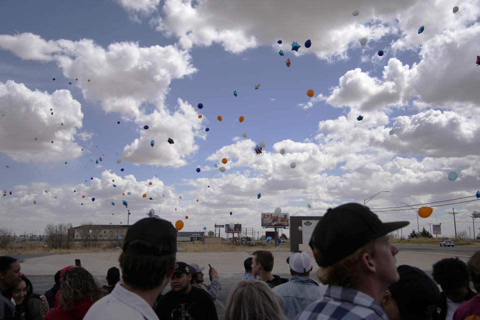 People watch after releasing balloons during a memorial for Jackson Zinn at a Texas Roadhouse restaurant, Thursday, March 17, 2022, in Hobbs, N.M.. Zinn, who worked at the restaurant, was killed with several other student golfers and the coach of University of the Southwest in a crash in Texas. (AP Photo/John Locher)