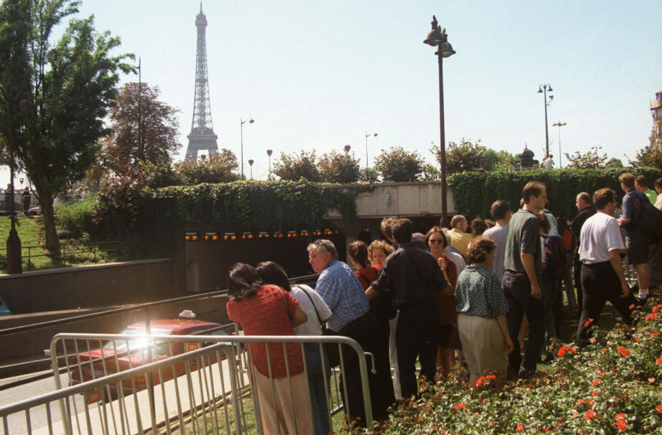 FILE - Onlookers gather outside the entrance of the Alma Bridge tunnel in Paris, Aug. 31, 1997, where Diana, Princess of Wales, her companion Dodi Fayed, and the driver of their car were killed in a car crash early Sunday. The story of Princess Diana's death at age 36 in that catastrophic crash in a Paris traffic tunnel continues to shock, even a quarter-century later. (AP Photo/Jerome Delay, File)