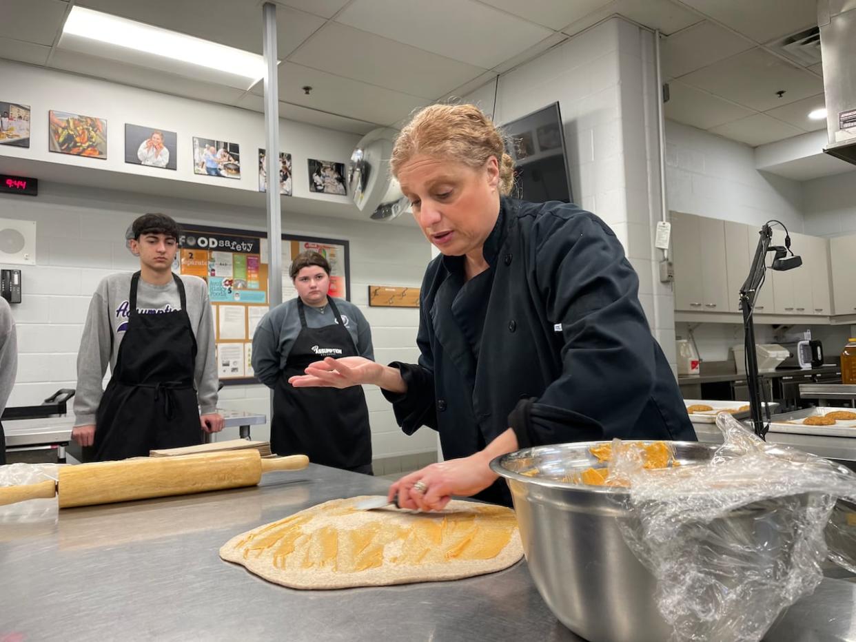 Diane Nehmetallah is the teacher in the culinary program at Assumption College Catholic High School. She says she teaches the course with an emphasis on practical skills and minimizing waste amid high food prices.  (Amy Dodge/CBC - image credit)