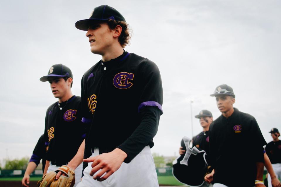 Hickman baseball junior Reiss Beahan (16) walks to the dugout after warming up prior to the Kewpies' 4-2 win over No. 1 Rock Bridge on Wednesday at Rock Bridge High School.