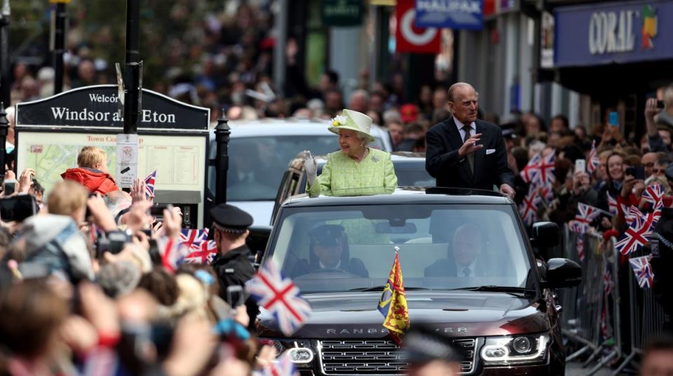 The Queen and Philip ride in an open-top Range Rover in Windsor to mark the monarch’s 90th birthday (Steve Parsons/PA) (PA Archive)