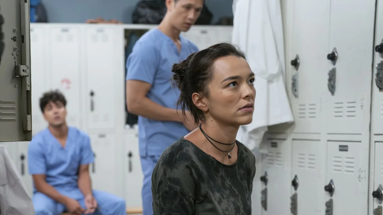  Mika Yasuda (Midori Francis) is shown on Grey's Anatomy with Lucas Adams and Blue Kwan in the background. 