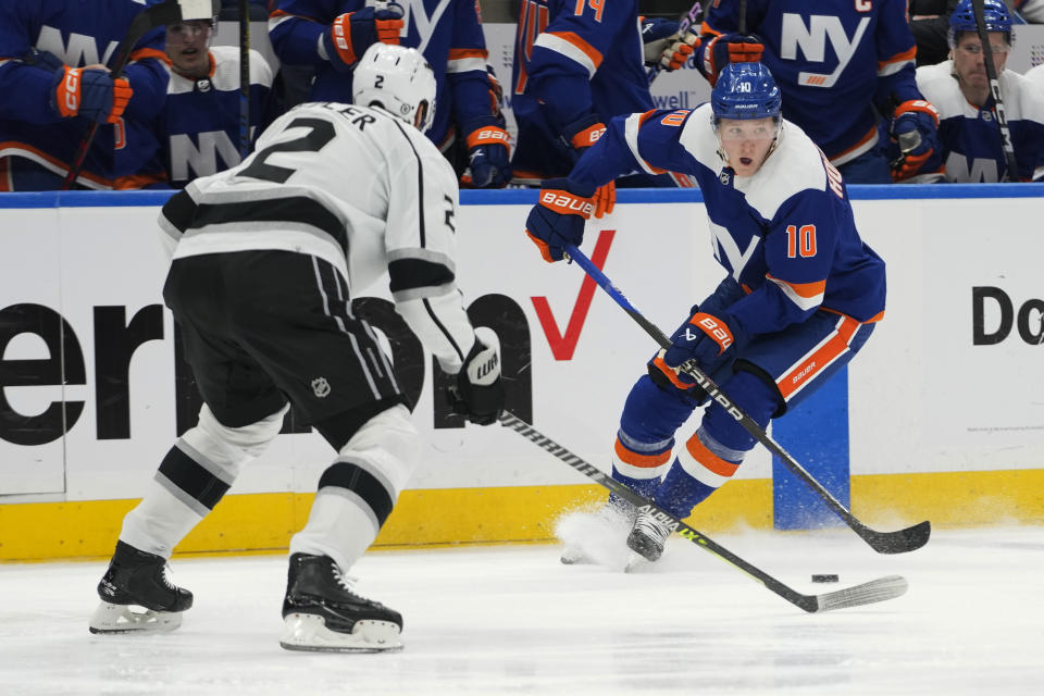 New York Islanders right wing Simon Holmstrom (10) skates against Los Angeles Kings defenseman Alexander Edler (2) during the second period of an NHL hockey game Friday, Feb. 24, 2023, in Elmont, N.Y. (AP Photo/Mary Altaffer)