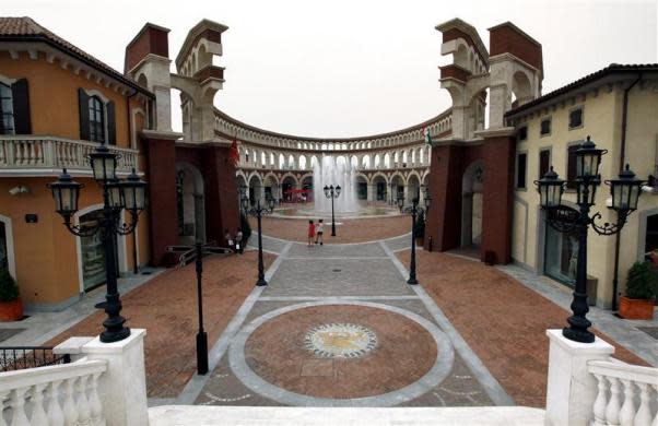 Two women walk through a building that resembles a Roman Coliseum at the Florentia Village in the district of Wuqing, located on the outskirts of the city of Tianjin June 13, 2012. <br><br><a href="http://news.yahoo.com/photos/china-replicates-austrian-village-slideshow/" data-ylk="slk:Click here;elm:context_link;itc:0;sec:content-canvas;outcm:mb_qualified_link;_E:mb_qualified_link;ct:story;" class="link  yahoo-link">Click here</a> to see a related gallery: China replicates Austrian village