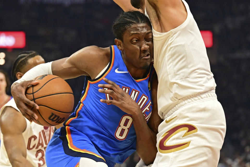 Oklahoma City Thunder forward Jalen Williams (8) drives against Cleveland Cavaliers guard Max Strus, right, in the first half of an NBA basketball game, Friday, Oct. 27, 2023, in Cleveland. (AP Photo/David Dermer)