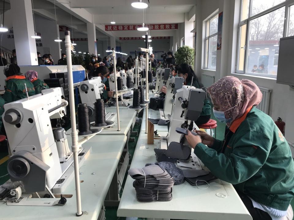 Hui minority women sew shoe interiors together at a "poverty alleviation factory" on the outskirts of Linxia.