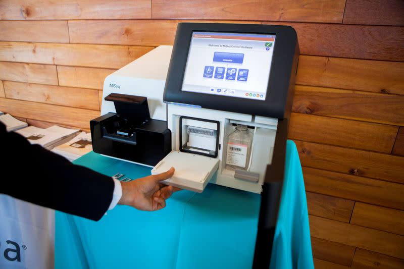 FILE PHOTO: Chintalapati, an inside sales consultant with Illumina, demonstrates how their bench top DNA sequencing machine Miseq works, in La Jolla