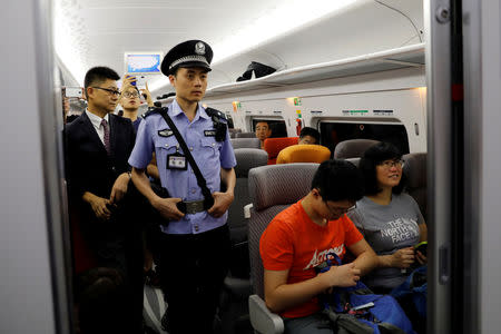 A Chinese policeman patrols a train during the first day of service of the Hong Kong Section of the Guangzhou-Shenzhen-Hong Kong Express Rail Link, in Hong Kong, China September 23, 2018. REUTERS/Tyrone Siu