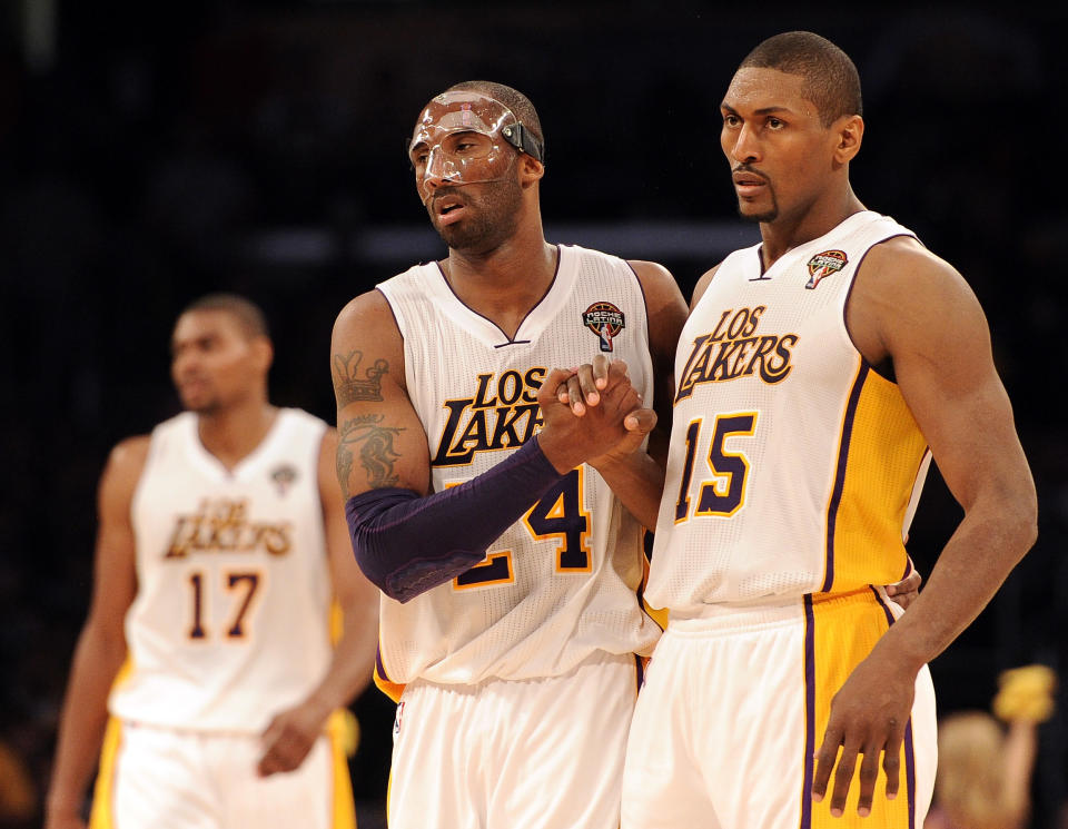 LOS ANGELES, CA - MARCH 04: Kobe Bryant #24 and Metta World Peace #15 of the Los Angeles Lakers celebrate after a stop in play during a 93-83 Laker win at Staples Center on March 4, 2012 in Los Angeles, California. NOTE TO USER: User expressly acknowledges and agrees that, by downloading and or using this photograph, User is consenting to the terms and conditions of the Getty Images License Agreement. (Photo by Harry How/Getty Images)