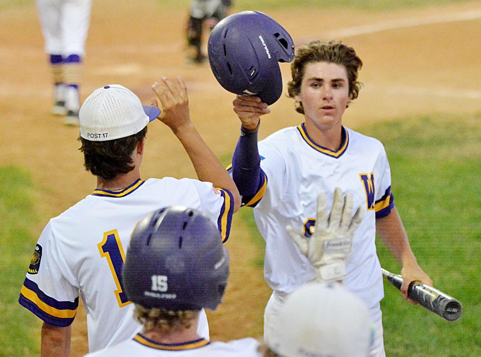 Watertown Post 17's Ryan Roby is congratulated by teammates after scoring a run during Thursday's American Legion Baseball doubleheader against Brandon Valley at Watertown Stadium. Brandon Valley swept the twinbill, winning 13-9 in eight innings and 10-1.