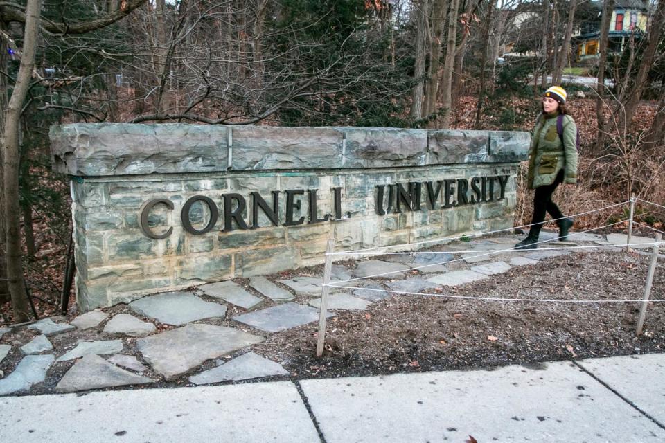 FILE - A woman walks by a Cornell University sign on the Ivy League school's campus in Ithaca, New York, on Jan. 14, 2022 (Copyright 2022 The Associated Press. All rights reserved.)