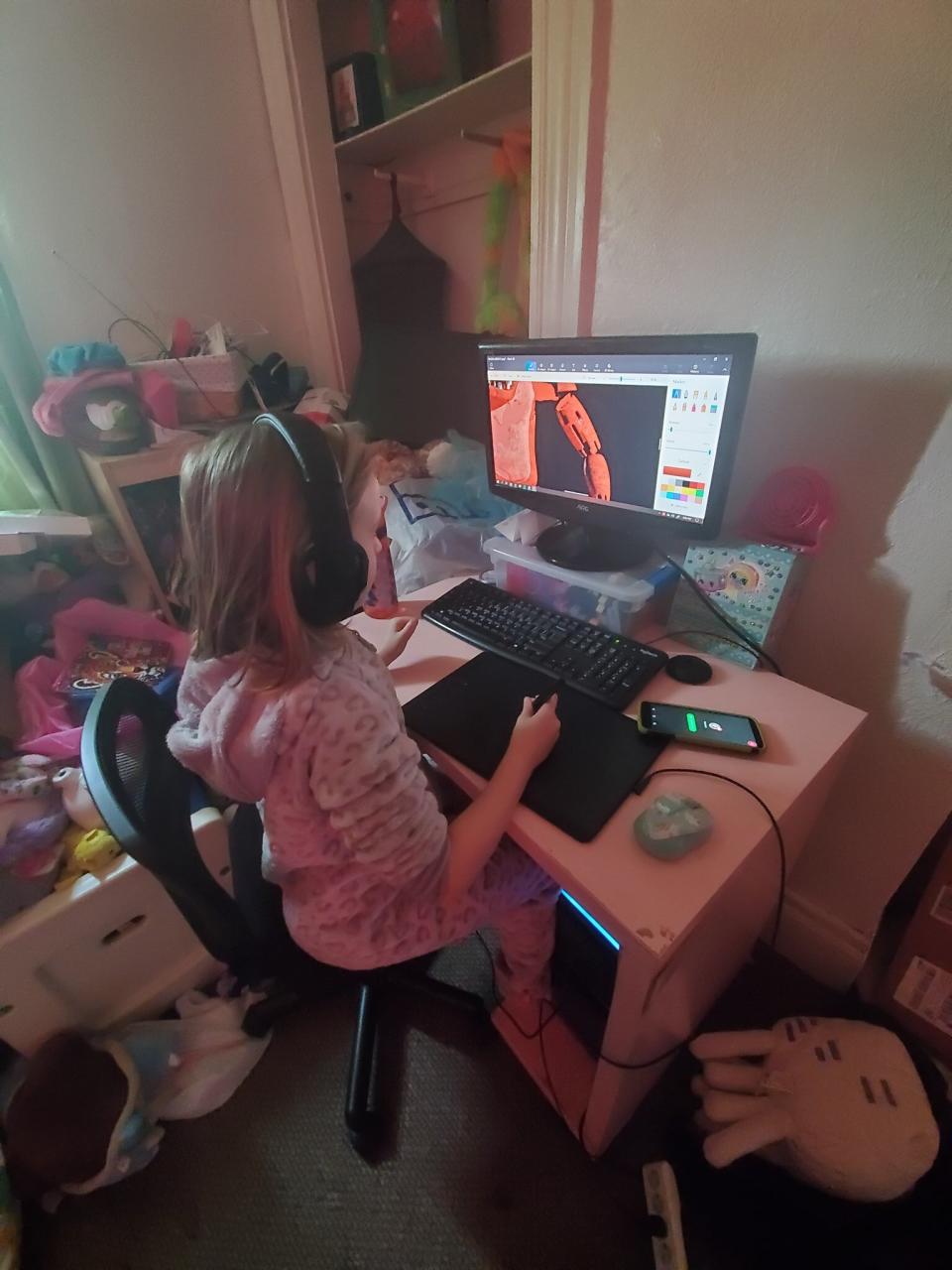 Moreau shared a photo of her nearly 9-year-old daughter at the computer, for size comparison. (Photo: Marie Moreau)