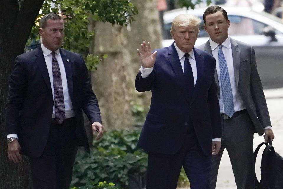 Former President Donald Trump, center, waves as he arrives for the funeral for his ex-wife Ivana Trump, Wednesday, July 20, 2022, in New York. Ivana Trump, an icon of 1980s style, wealth and excess and a businesswoman who helped her husband build an empire that launched him to the presidency, is set to be celebrated at a funeral Mass at St. Vincent Ferrer Roman Catholic Church following her death last week.(AP Photo/John Minchillo)