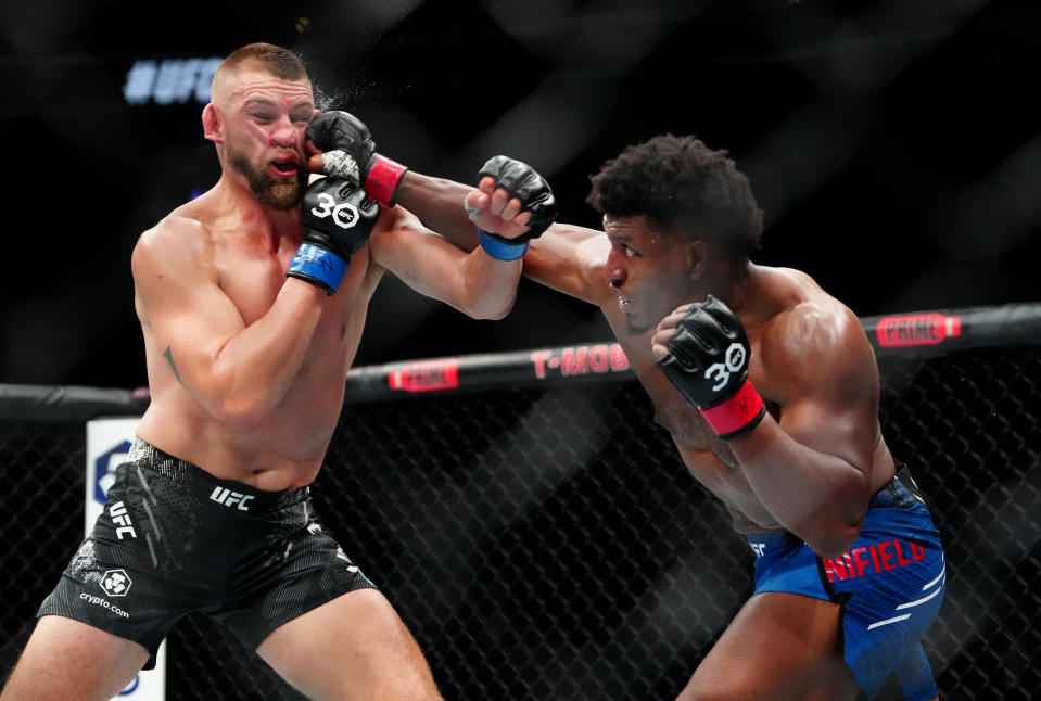 Dec 16, 2023; Las Vegas, Nevada, USA; Alonzo Menifield (red gloves) fights Dustin Jacoby (blue gloves) during UFC 296 at T-Mobile Arena. Mandatory Credit: Stephen R. Sylvanie-USA TODAY Sports