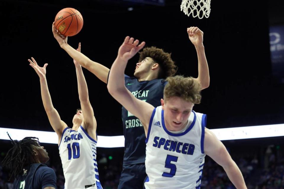 Great Crossing’s Malachi Moreno pulls in a rebound between Spencer County’s Keaton Baird (10) and Luke Erhardt (5) during Wednesday night’s first-round game in Rupp Arena. Spencer County coach Jason Burns knew the Warhawks’ height would be a problem. “We told them to eat their green beans this week, but you can’t grow 6 inches in a week.”