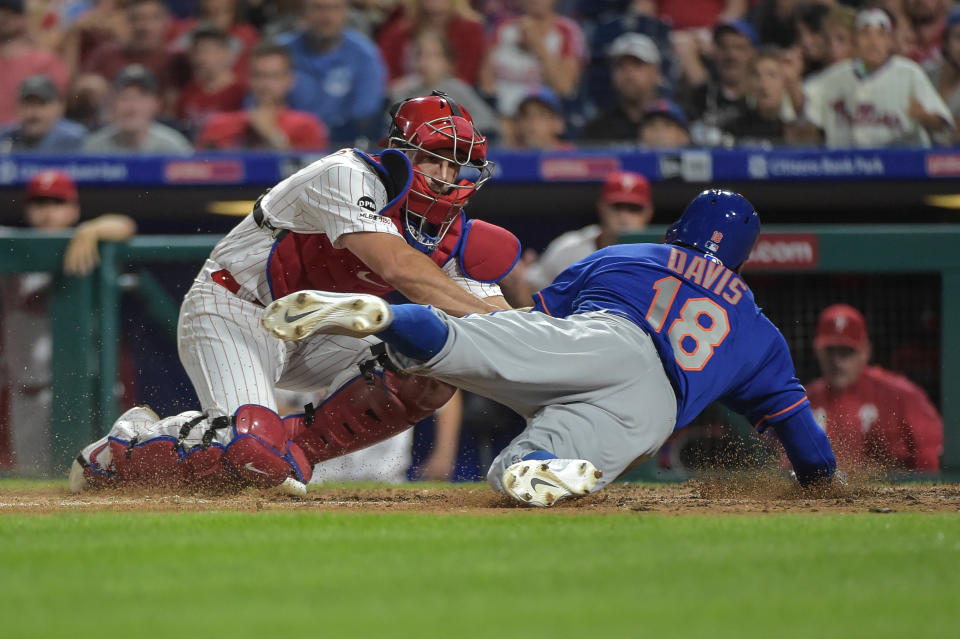 Sep 1, 2019; Philadelphia, PA, USA; Philadelphia Phillies catcher J.T. Realmuto (10) tags out New York Mets center fielder Rajai Davis (18) at the plate during the eighth inning of the game at Citizens Bank Park. Mandatory Credit: John Geliebter-USA TODAY Sports