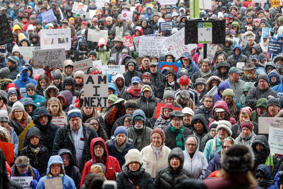 Demonstrators gather outside city hall during the March for Our Lives protest for gun legislation and school safety.