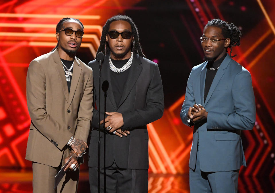 Quavo, Takeoff, and Offset standing on stage.