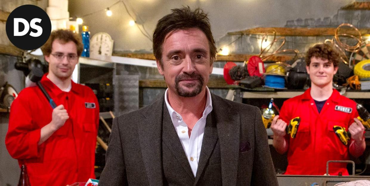 richard hammond in a dark three piece suit on the set of his show crazy contraptions