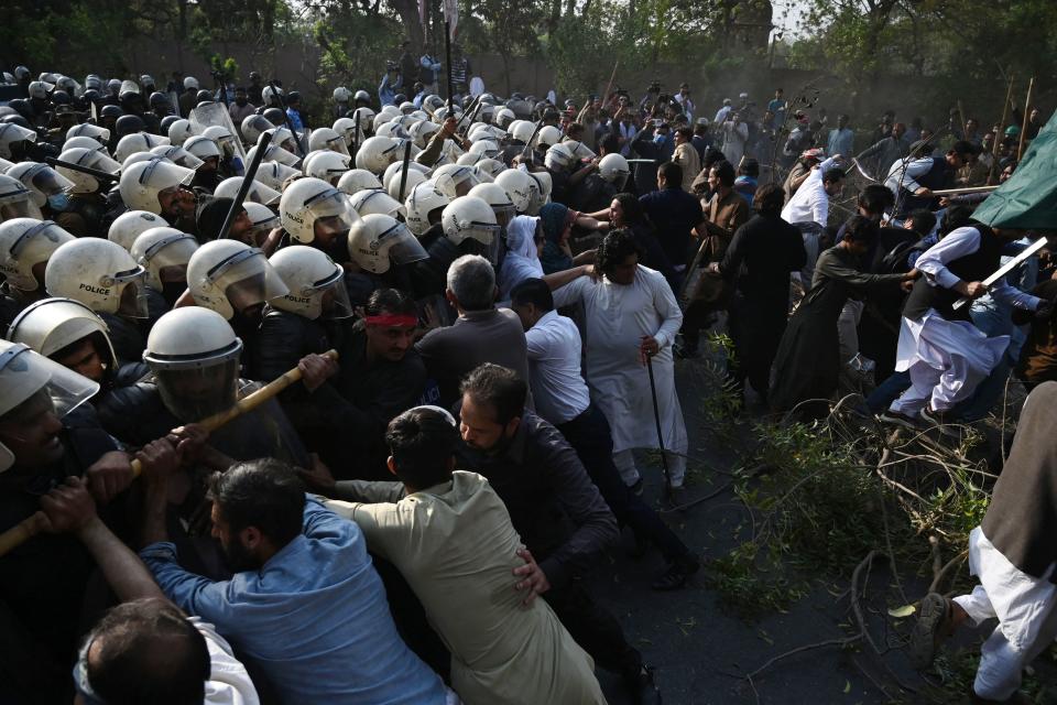 Riot police try to push back supporters of former prime minister Imran Khan gathered outside Khan's house to prevent officers from arresting him, in Lahore, Pakistan, March 14, 2023.<span class="copyright">Arif Ali—AFP/Getty Images</span>