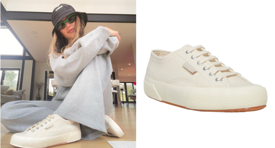 Hailey Bieber sitting on her floor wearing a bucket hat and Superga 2706 OG Beige sneakers