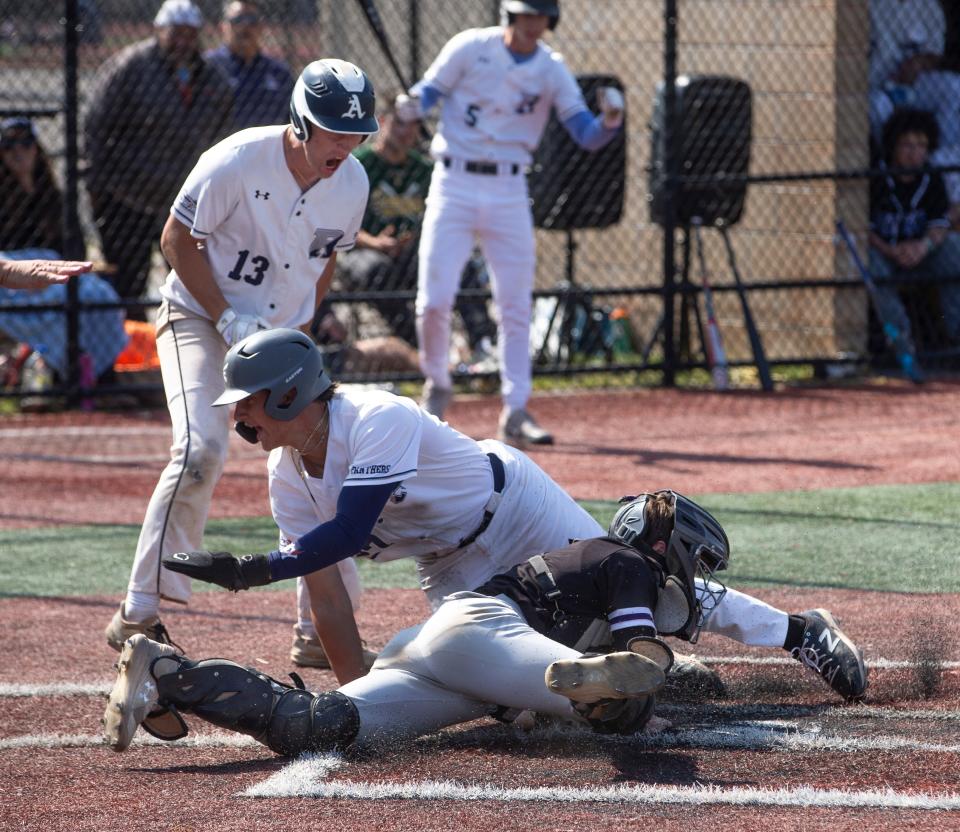 Ranney’s A.J. Gracia slides in safe at home as teammate Jack Tallent watches. Rumson-Fair Haven catcher Owen Kenney attempts the tag. Shore Conference Baseball Tournament semifinals featuring Rumson-Fair Haven vs. Ranney.  Red Bank, NJThursday May 18, 2023