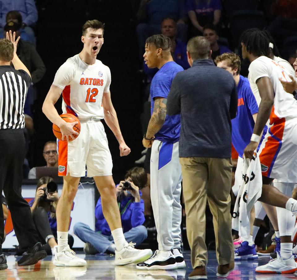 University of Florida Gators forward Colin Castleton (12) celebrates a play near the Florida bench during a game against the Milwaukee Panthers, at Exactech Arena in Gainesville Nov. 18, 2021. The Gators won 81-45 over the Panthers.