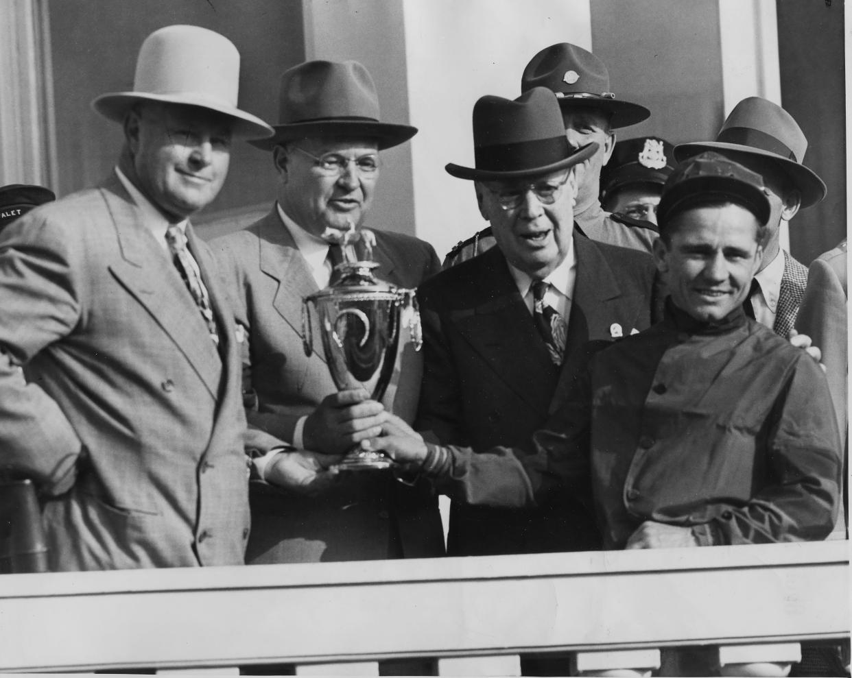 The late Col. Matt Winn with jockey Steve Brooks. The Derby winning horse was Ponder. May 7, 1949.