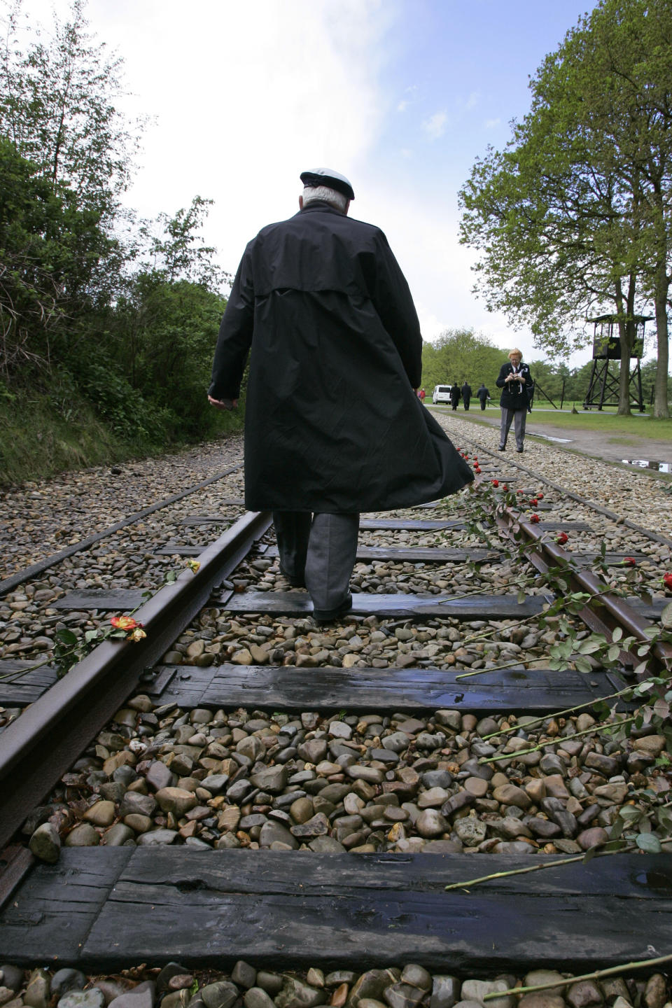 In this Monday May 9, 2015, file photo, a World War II veterans walks on the railroad tracks at former concentration camp Westerbork, the Netherlands, Monday May 9, 2005, remembering more than a hundred thousand Jews who were transported from Westerbork to Nazi death camps. The Dutch national railway company NS says it will set up a commission to investigate how it can pay individual reparations for its role in mass deportations of Jews by Nazi occupiers during World War II. (AP Photo/Peter Dejong)