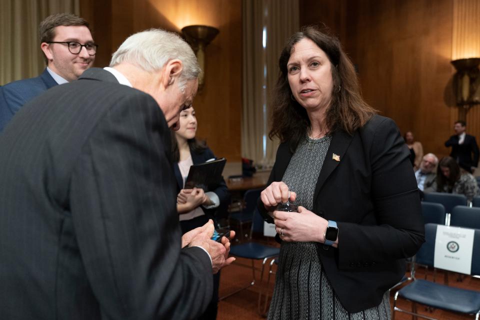 Committee member Sen. Tom Carper, D-Del., talks to Colleen Shogan, nominee to be the archivist of the U.S. National Archives and Records Administration, after the Senate Homeland Security and Governmental Affairs Committee hearing on Shogan's nomination on Feb. 28.