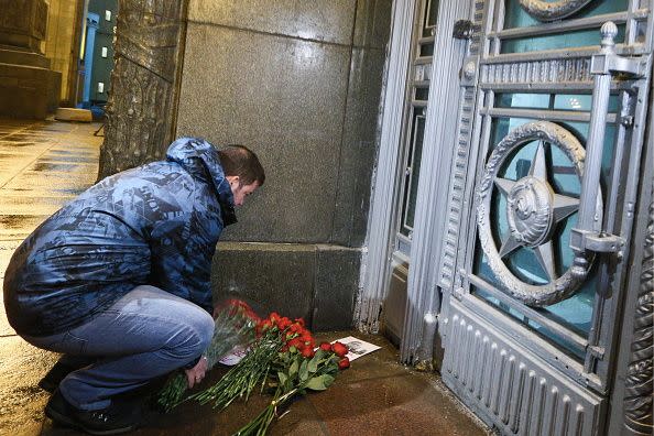 A man lays flowers at the entrance to the Russian Foreign Affairs Ministry building to pay tribute to the murdered Russian Ambassador to Turkey Andrei Karlov. Photo: Getty