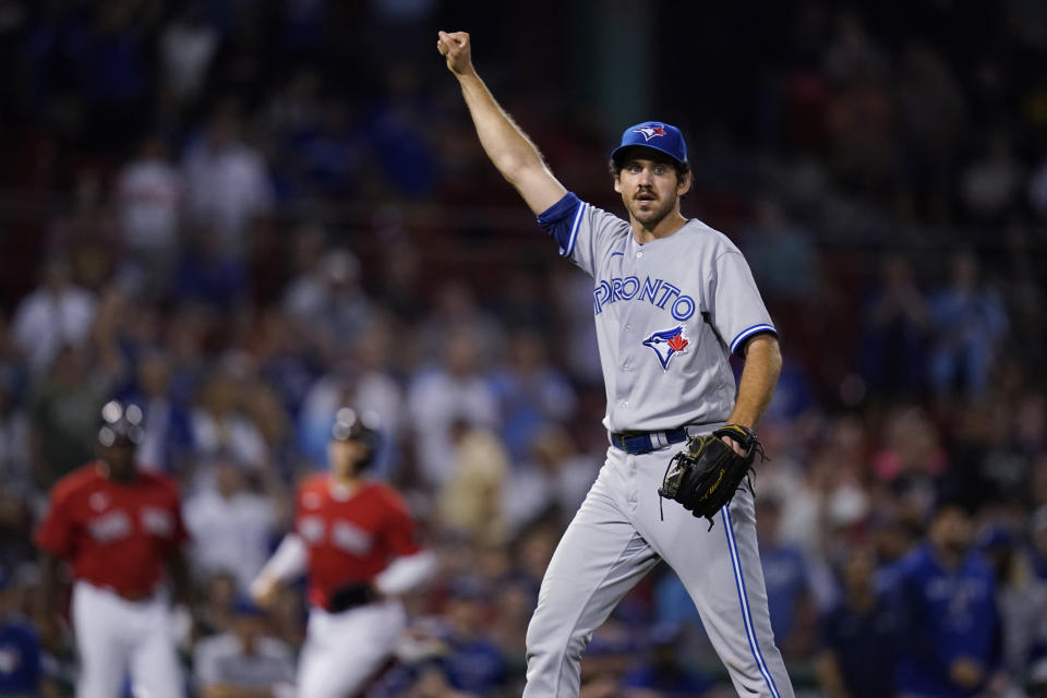 Toronto Blue Jays relief pitcher Jordan Romano raises his arm after the final out in the bottom of the 10th inning to defeat the Boston Red Sox in a baseball game Thursday, Aug. 25, 2022, in Boston. (AP Photo/Charles Krupa)